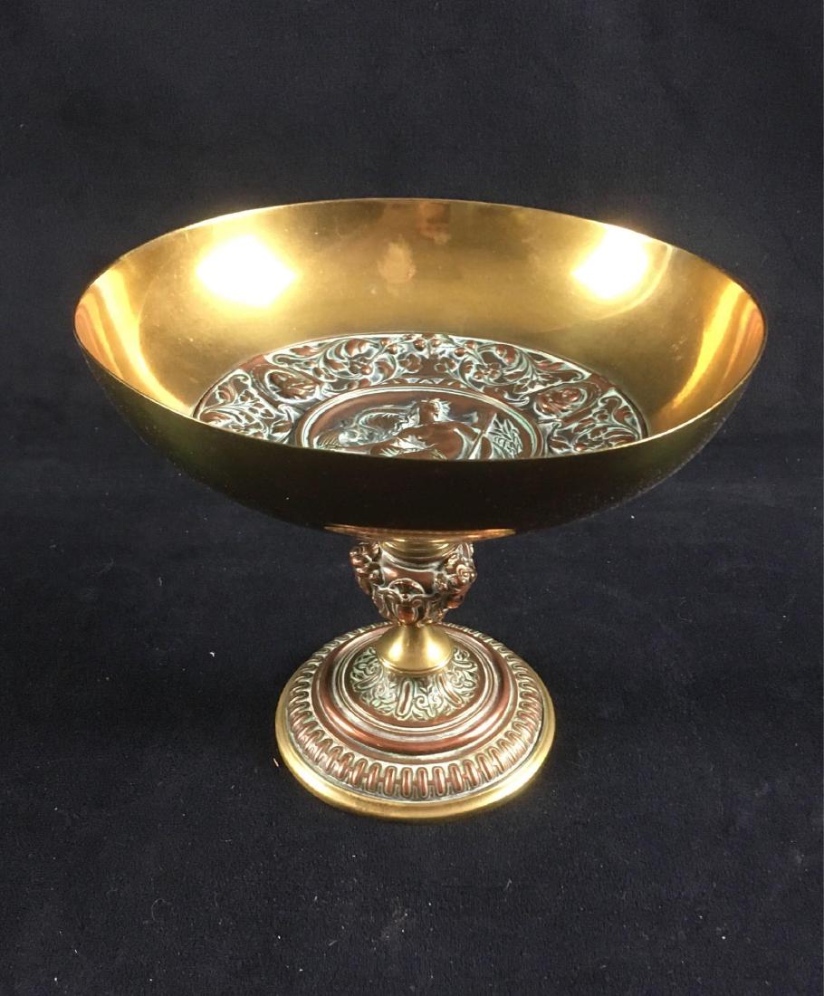 Brass Roman Decorative Chalice: Classical style chalice dish made of brass. This piece is weighted and is of good quality, but is unmarked. It likely dates from the 1970's.Â It measures 6" tall and has a 7.1/4" diameter.Â