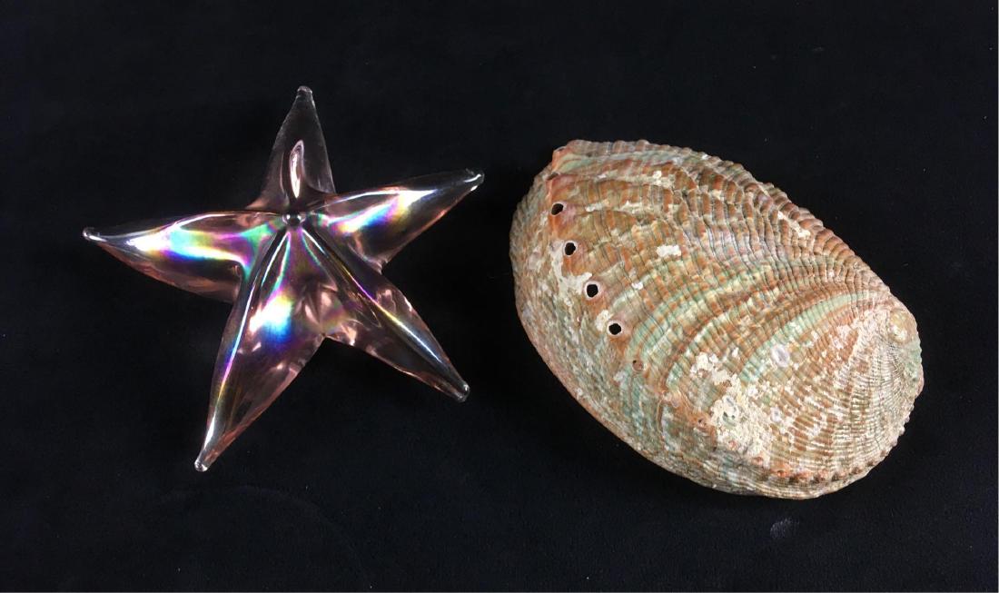 Abalone Shell Art Glass Starfish: Tropical decor lot, including one 5.3/4" Abalone shell, and one 5.1/2" diameter solid, art glass starfish. Both are in excellent condition. Perfect for your beach house or Island themed home.Â
