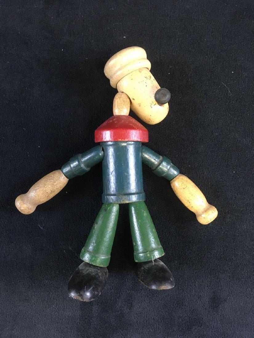 1930 Popeye Wooden String Puppet Figure: Popeye figurine made of wood and attached with string. This example is in decent condition with wear to the finish and details. See photos for specific condition. It measures approx 6" tall.