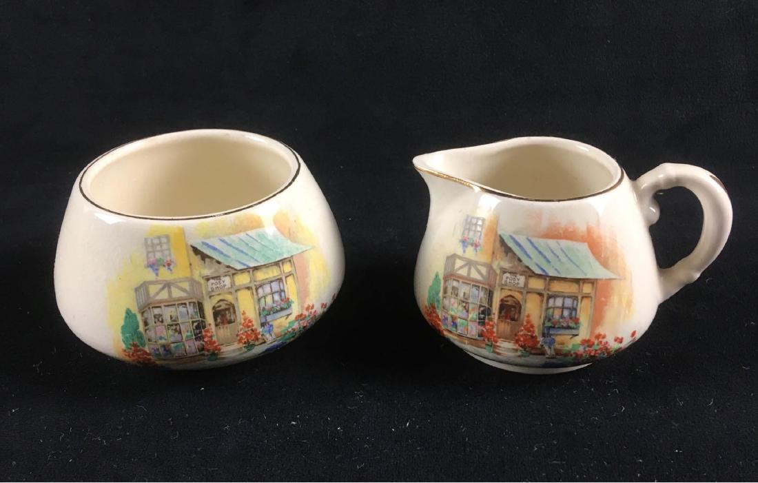 Vintage English Ware Lancaster Sandland Creamer and: Cream and Sugar set from L&S England. Set features a lovely corner shop and flowers. It is in nice condition. Sugar measures 2.1/2" tall, 3.3/4" in diameter. Creamer is 2.3/8 tall 3.1/4" in diameter.�