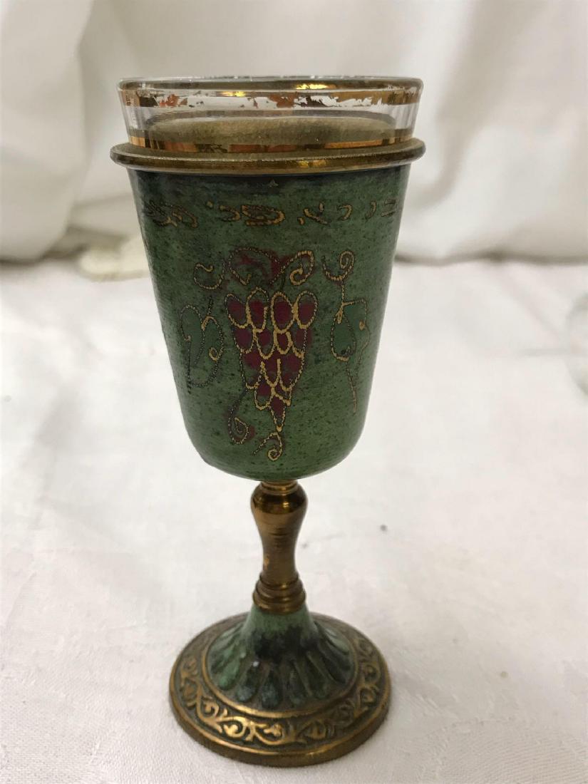 Vintage Kiddush Cup: Vintage Kiddush Cup; A lovely glass Kiddush cup with a metal holder. The metal cup has a lovely teal patina finish embossed with a bushel of grapes gilded in gold. Marked Made in Israel. Measures at a