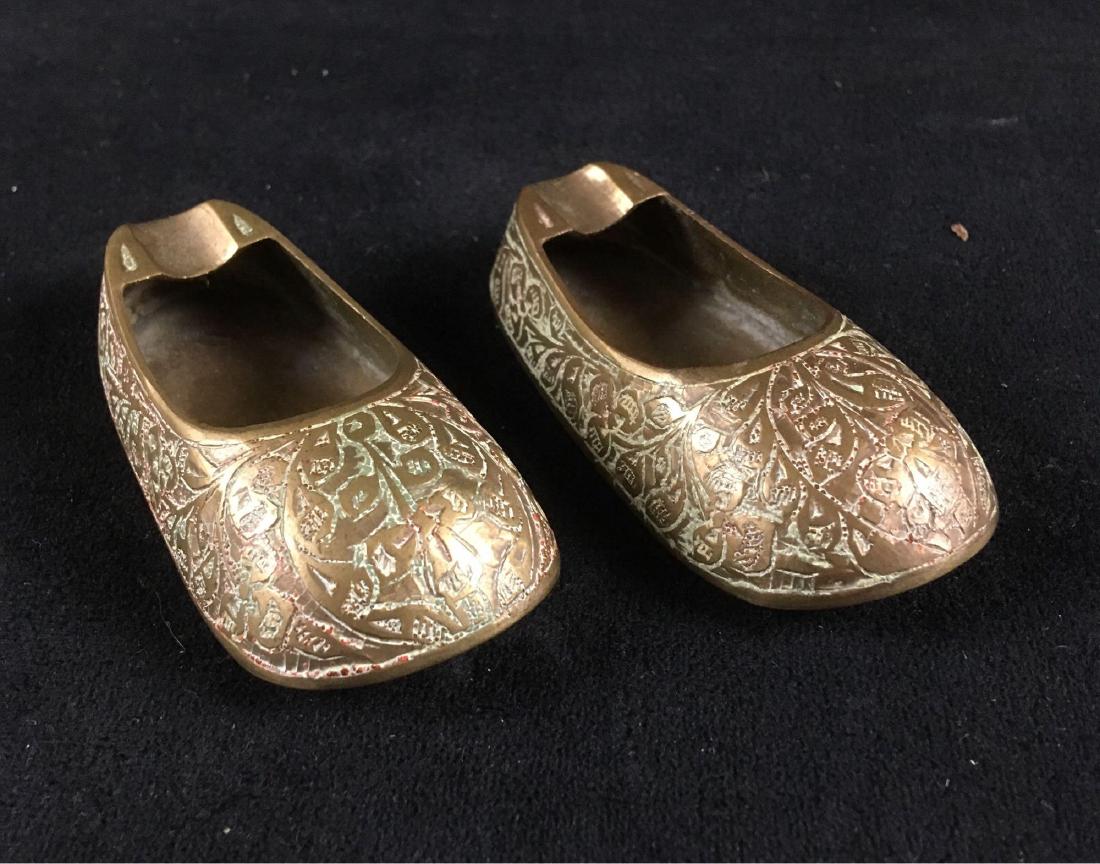 Vintage Brass Slipper Ashtray Lot: Brass white slippers pair of ashtrays, circa 1960's or 70's, likely made in India. The slippers have an Indian or Eastern theme. 3.1/4" L, 1.1/4" W, .3/4" H
