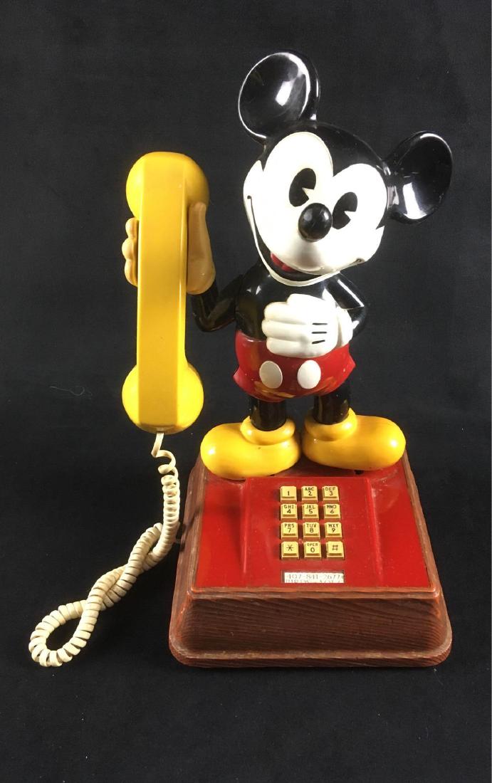 Vintage The Mickey Mouse Phone by American: Vintage The Mickey Mouse Phone by American Telecommunications, Circa 1970's; a touch tone telephone showing Mickey holding the receiver. The phone appears to be complete but is untested. It is in good