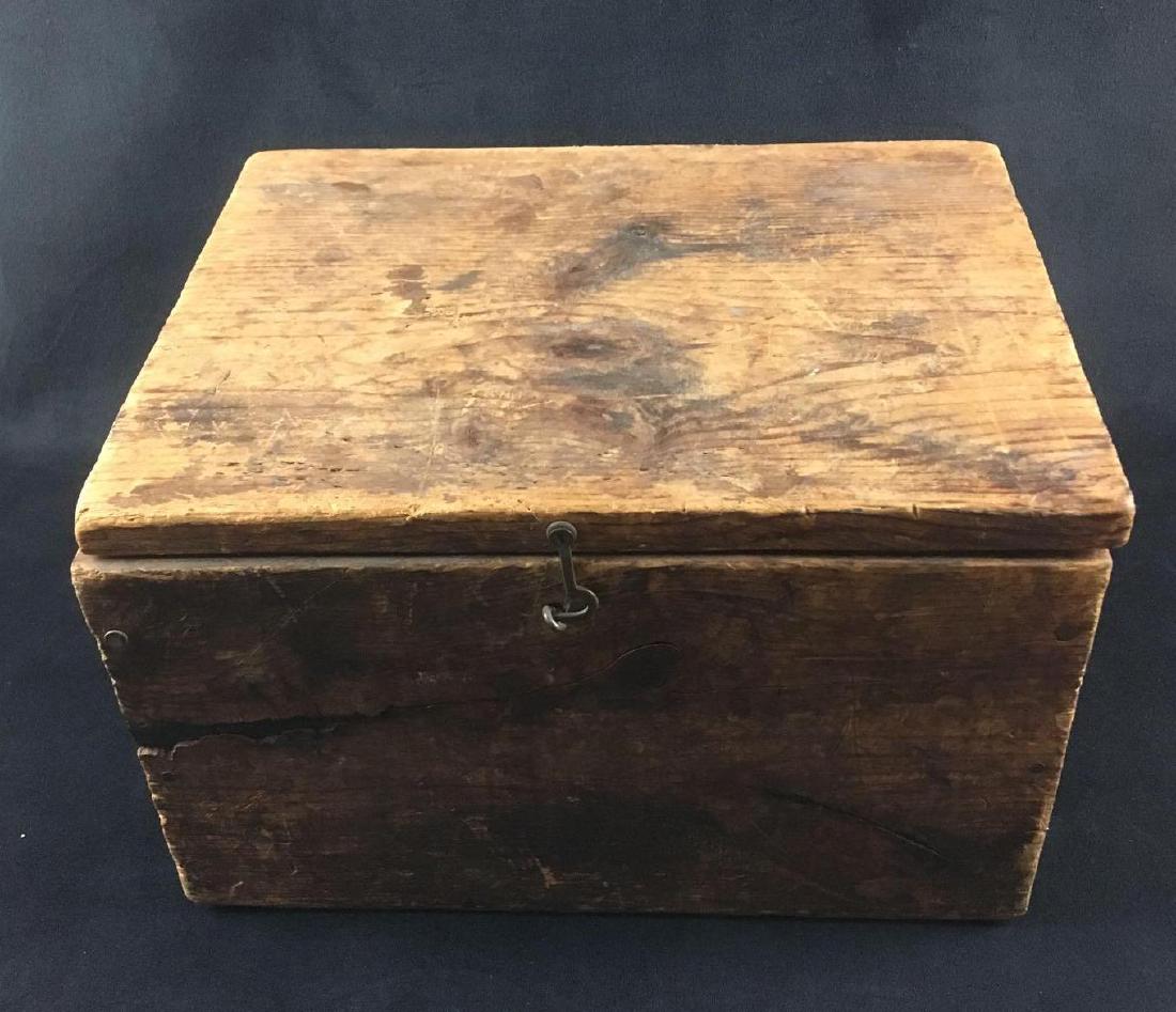Handmade Pine Wooden Keepsake Box with Clasp: Handmade Pine Wooden Keepsake Box with Clasp. This box is in fair condition. It is a simple box with a clasp on the front. The box has some scratches and cracks in the wood. The exterior of the box is