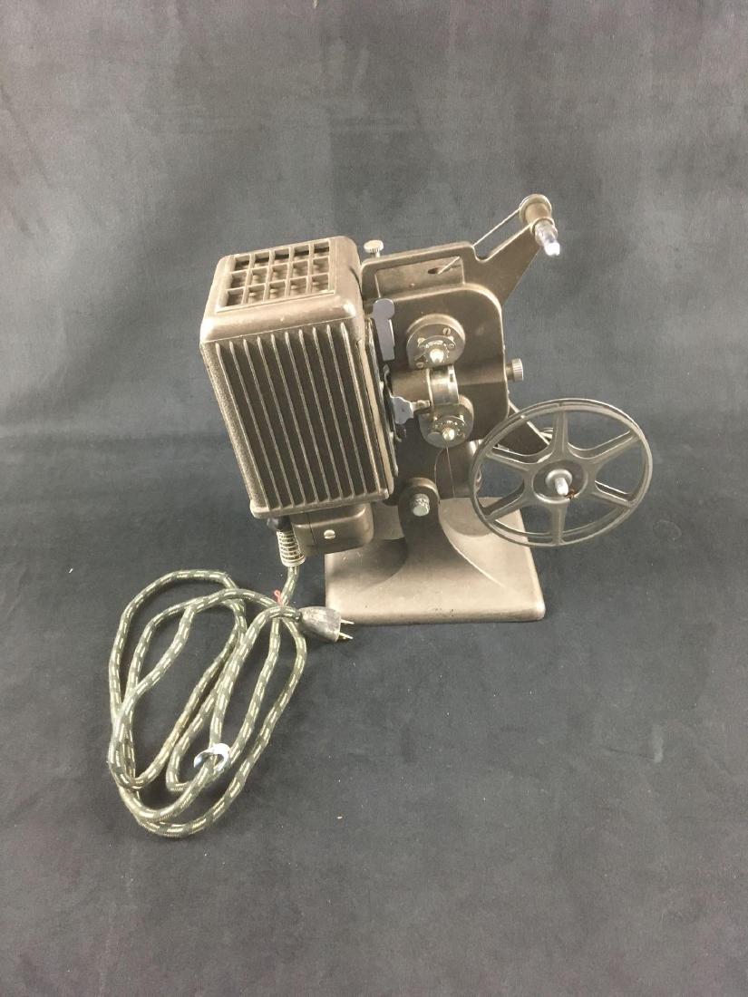 Vintage 8 MM Projector, Kodascope 8 Model 70 by Eastman: Vintage 8 MM Projector, Kodascope 8 Model 70 by Eastman Kodak, Circa 1930's; a great vintage piece that appears to work. We were brave enough to plug it in and the noted the fan motor runs, the lamp l