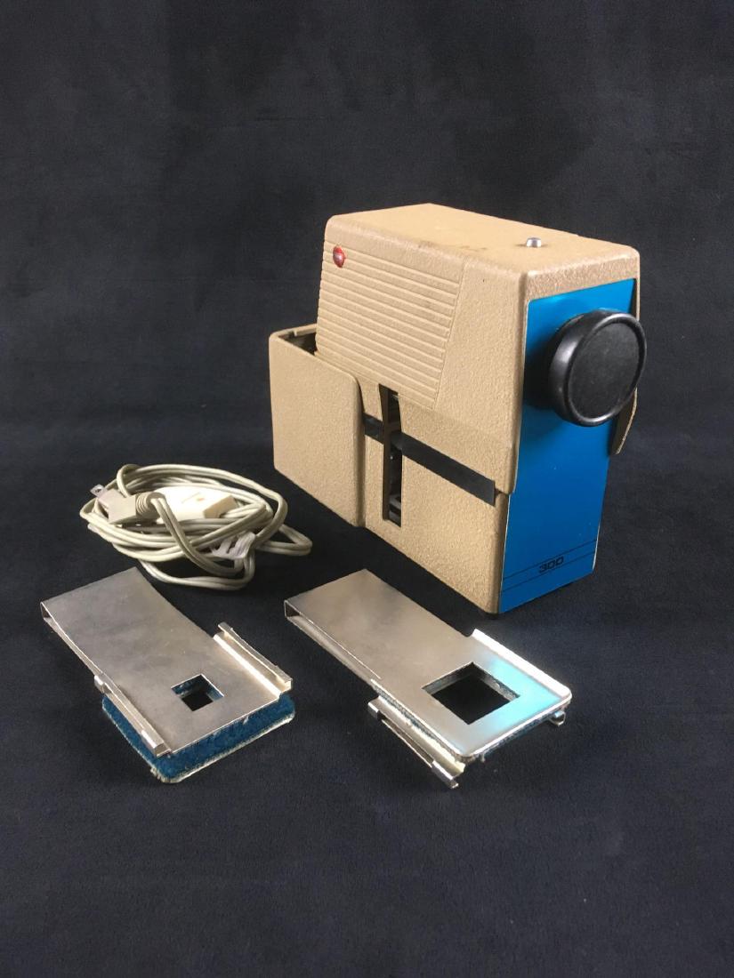 Vintage Taylor Merchant Slide Micro Projector: Vintage Taylor Merchant Slide Micro Projector in Original Packaging; this Mid Century Modern piece of technology includes two slide holders, one is marked "Model F for #300" (110 film size slides?) an