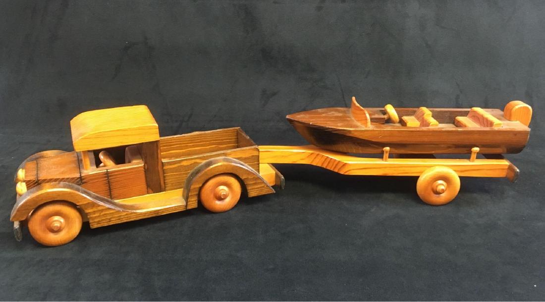 Hand Crafted Wooden Toy Truck and Boat on Trailer: Hand Crafted Wooden Toy Truck and Boat on Trailer; the truck appears to be based on a Ford Model A , the boat appears to be one of the early Chris Craft runabouts. It is marked "Hand Crafted By Ray Wi