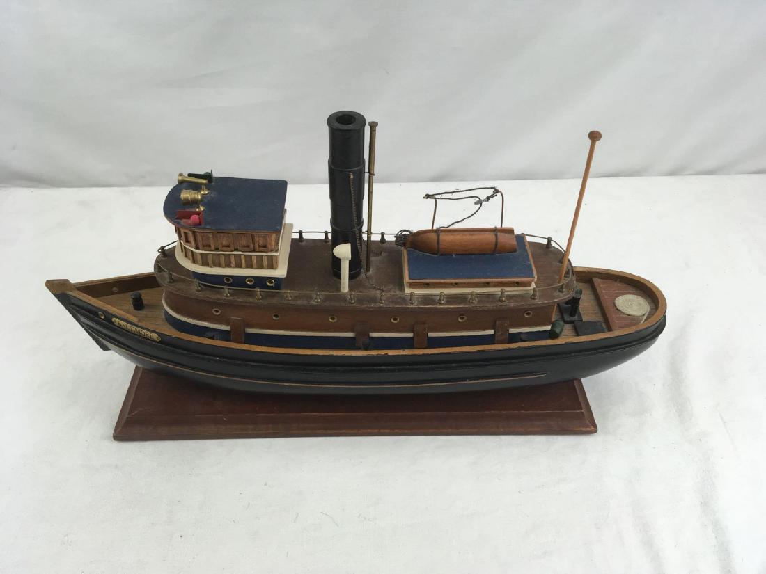 Wood Ships Model, the Tug Baltimore: Wood Ships Model, the Tug Baltimore; this appears to be a model of the tug Baltimore, the oldest operating steam powered tugboat in the US. This model is mounted on stand and 4 3/4 beam x 19 12" lengt