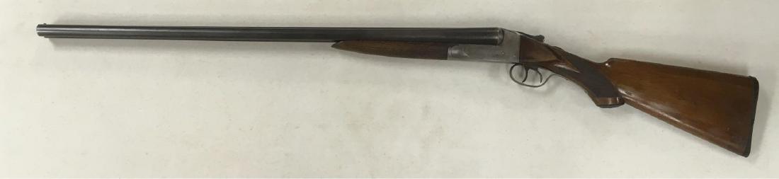 Antique Double Barrel Shotgun Ithaca Gun Co 12 GA: Antique Double Barrel Shotgun, Ithaca Gun Co., 12 GA; this gun is marked with the IthacaÂ Gun Co. marks and shows an engraving of a hunting dog on each side of the receiver. The barrels show a wavy�