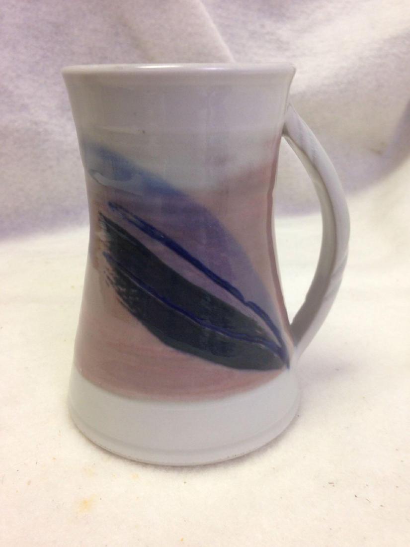 fun hand-made clay pottery coffee mug with leaf: This fine clay stoneware cup shows true craftsmanship and has a lovely leaf accent.Â Â Size: 5" H x 3" D. Colors: white, purple, mauve. Feel/Vibe: 80's, Peaceful. Other Info: Stoneware, Artisan, C