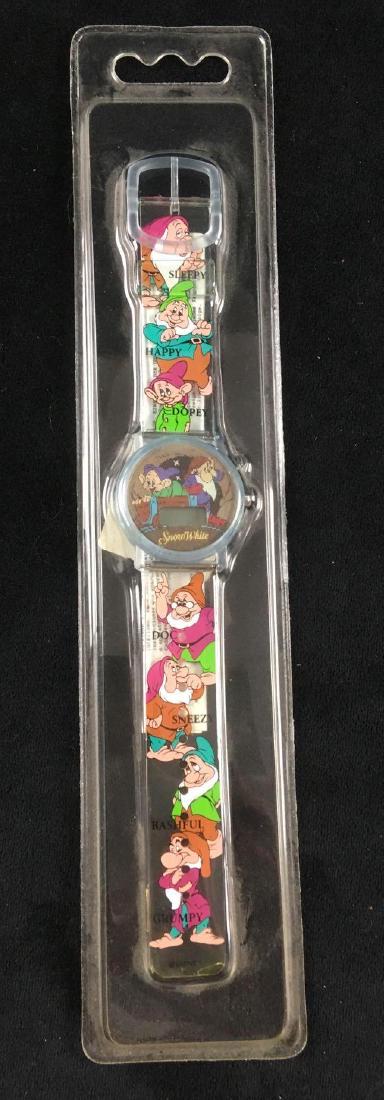 Disney Snow White Wrist Watch: Disney Snow White Wrist Watch. This wrist watch is in excellent condition. The watch is made of clear plastic with images of the 7 dwarves and their names printed on the band. The watch face has a hol