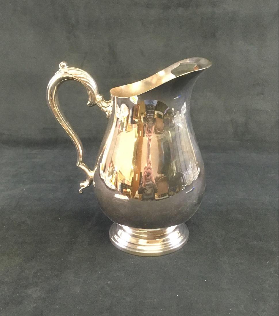 WM Rogers Silver Plated Pitcher: Silver plate pitcher, model #617, by W.M. Rogers. Item is in nice condition and measures 9" tall, with a 4.1/8" diameter base.