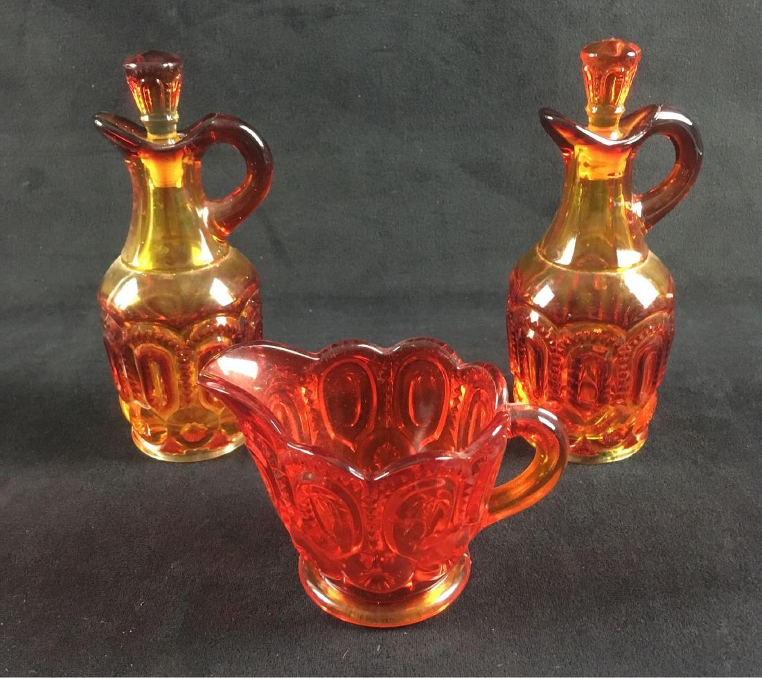 LE Smith Moon And Stars Amberina Cruet Creamer Set: LE Smith Moon And Stars Amberina Cruet Creamer Set; This set includes 2 cruets (7" H x 2 1/4" D) and a creamer (3 3/4" H x 4 1/4" W x 3" D) Set has a total of 5 pieces if you include the cruet toppers