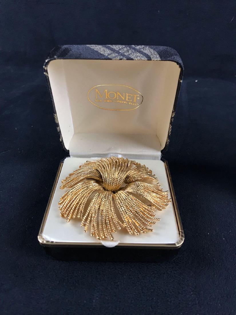 Vintage Gold Toned Monet Sunburst Brooch: Vintage Gold Toned Monet Sunburst Brooch; In excellent condition and comes with it's original box. The piece is signed and measures at about 2 3/4" D.