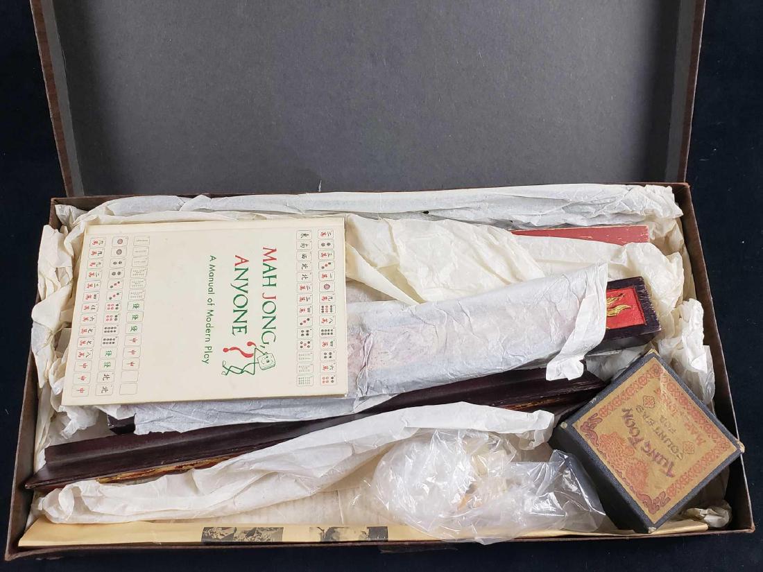 Chinese Dragon Mahjong Set: Chinese Dragon Mahjong Set. This set is in good condition. There is slight wear on the racks. The set contains 4 gold Chinese dragon racks, 1 doubling scale rack, Tung Foon counters, a play manual cal