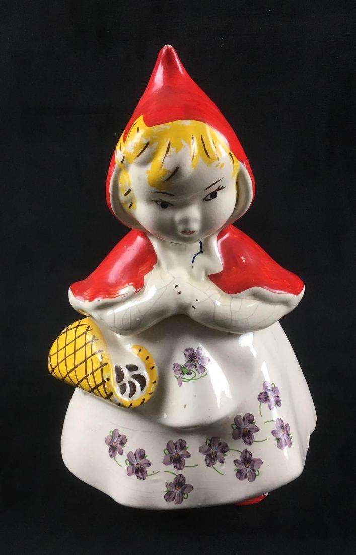 Little Red Riding Hood Cookie Jar: Little Red Riding Hood Cookie Jar. This cookie jar is in fair condition. The cookie jar has some missing paint. There are some chips in the porcelain. It is 12" tall 8" wide.Â