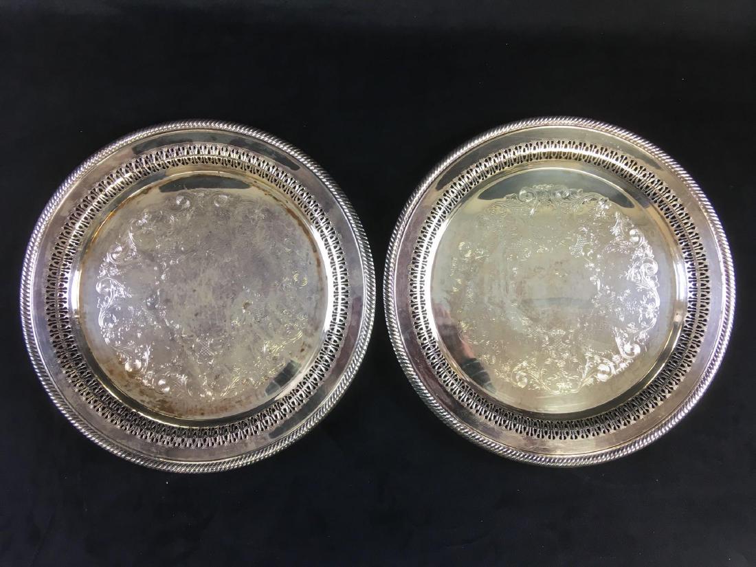WM Rogers Silver Matched Platter Set: A pair of matching W.M. Rogers silver plated platters. Both platters measure approx 12.1/4 in diameter, 7/8" H. Both in good condition.