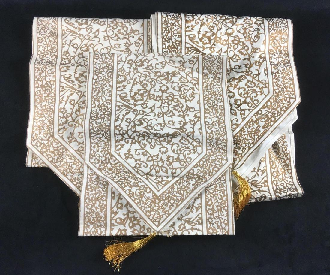 Indian Tasseled Table Runners: Indian Tasseled Table Runners. These table runners are in fair condition. Three of the six gold tassels need to be reattached and the runners are slightly dirty and need to be washed. The color of two