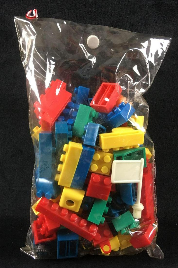 Vintage Assorted Legos: Vintage Assorted Legos. This is a set containing 78 pieces. The set contains two sets of two wheeled Legos, one set of four wheeled Lego, two Legoman heads, and two lego flags. The original manufactur
