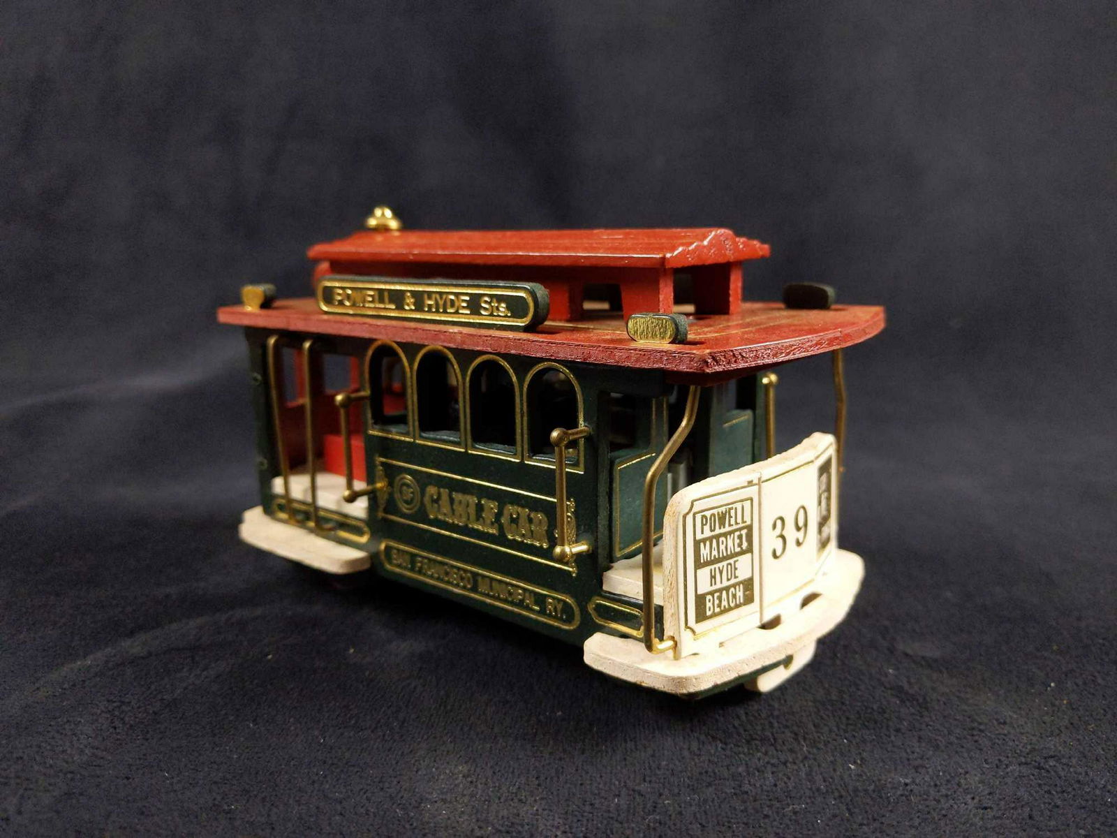 Wooden Wind Up San Francisco Train Toy: Vintage Wood Red Green and White San Francisco Powell and Hyde Sts. Cable Car Train Wind Up Toy. Winding/ music was tested and works fine.Wheels roll with ease. Used. Good Condition . 5.5" Lengt