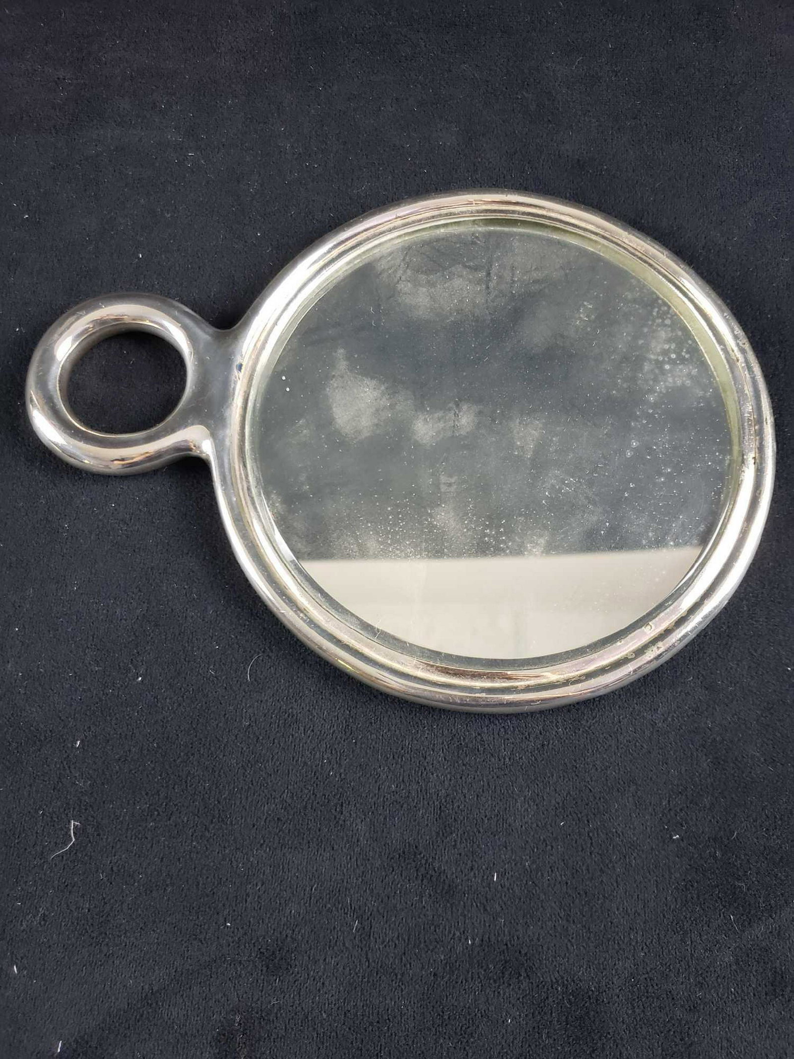 Vintage Sterling Silver Hand Mirror by Tiffany: Vintage Sterling Silver Hand Mirror Marked Tiffany & Co.; a short handled mirror. The frame shows a smooth clean finish. It is marked Tiffany & Co. on the bottom of the handle. The initials "GCK" are 