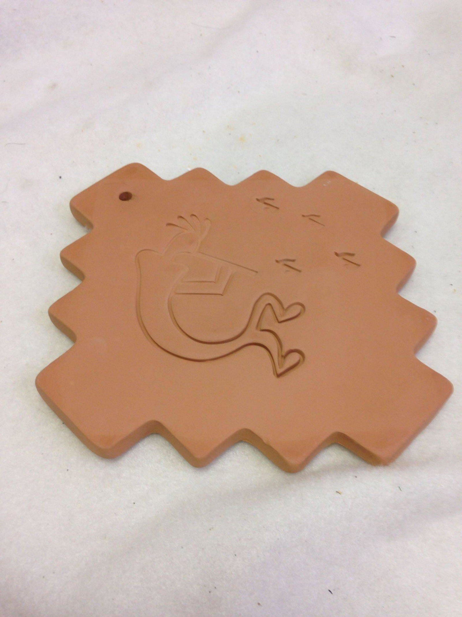 Southwestern Native American Terra Cotta Tile trivet: Southwestern Native American Terra Cotta Tile trivet. Catch the vibe off this one just by looking at the flute player having all the fun. Size: 7" x 7" oddly. Materials: Clay, Terra Cotta,