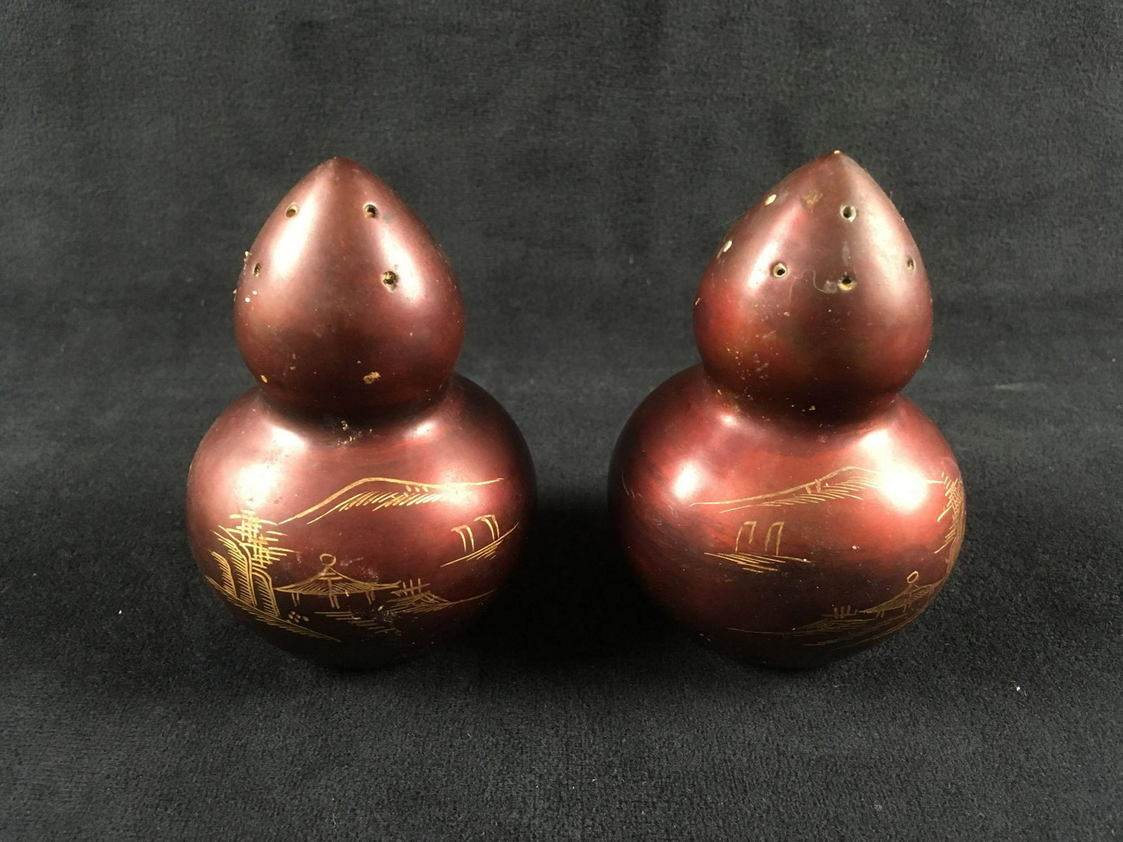 Vintage Japanese Red LacquerwareÂ Salt and Pepper Set: Vintage Japanese Red Lacquerware Salt and Pepper Set; these show a pagoda shape with a scene etched and accented with gold paint. Both pieces are in very good condition. Each measures 3 1/2" H x 