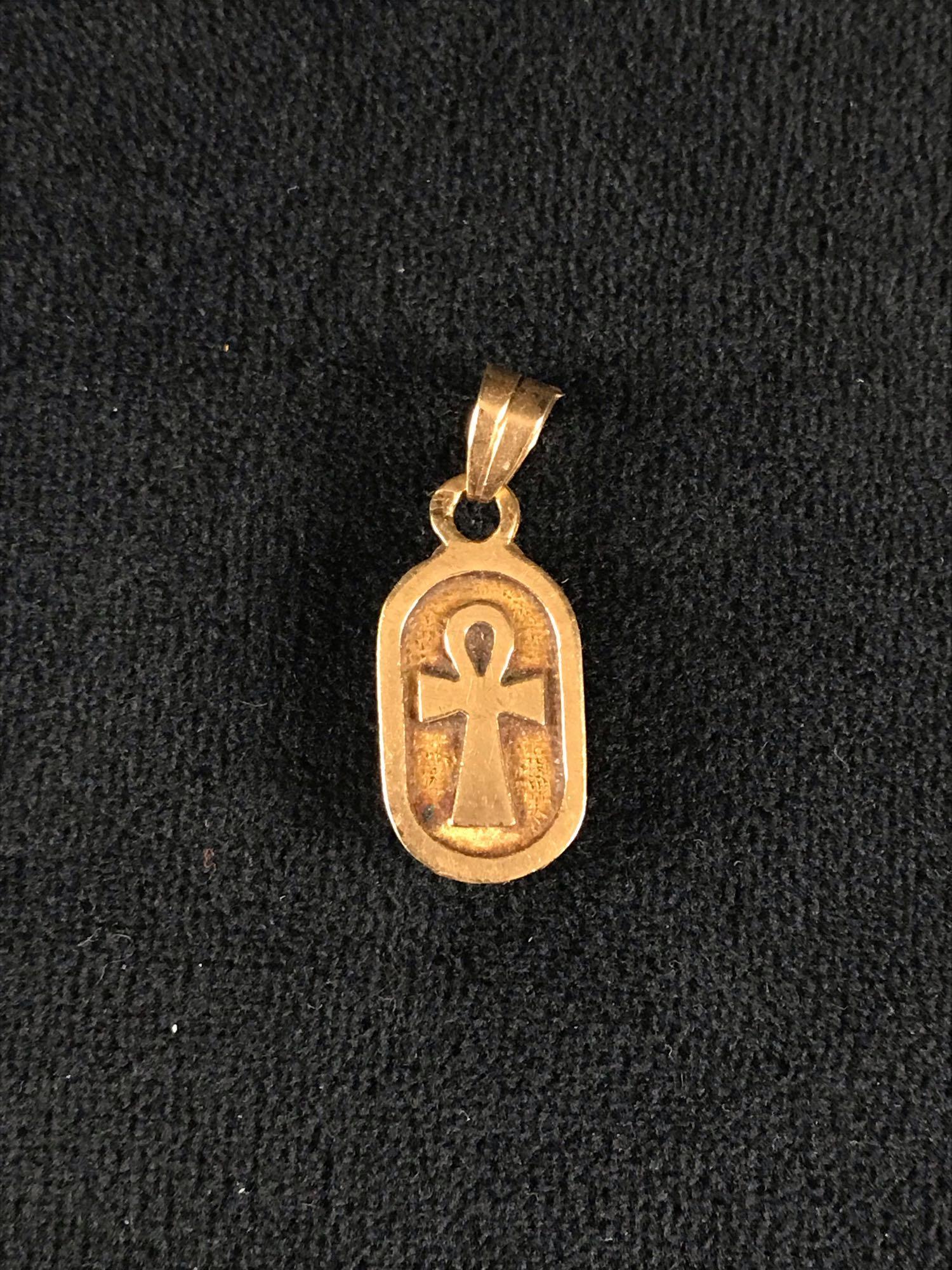 14k Gold Double Sided Egyptian Pendant: 14k Gold Double Sided Egyptian Pendant; This pendant is reversible and features a lapis lazuli scarab on one side and the ancient Egyptian ankh symbol on the other. It is in excellent condition and me