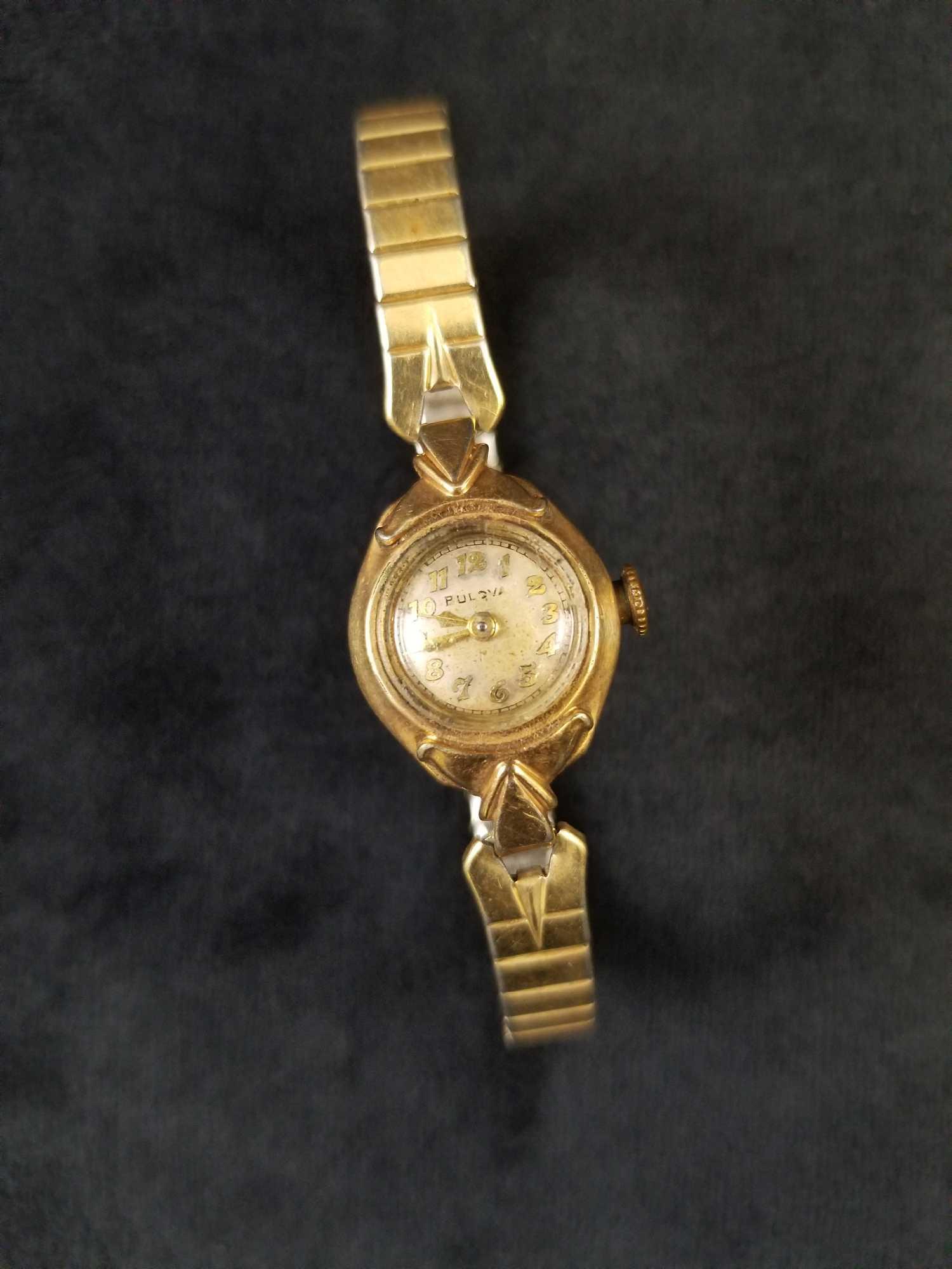 Vintage 1930s Bulova 10k Womens Watch: This vintage 1930's Bulova 10k women's watch is in good vintage condition. The glass front is cloudy and has minor cuffing from wear and age. The size of the face is approximately half an inch. Stainl