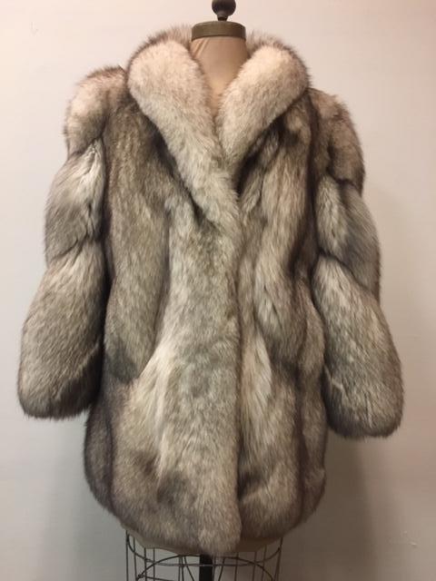 Very Fine Wrap Style Silver Fox Fur Jacket: Very Fine Wrap Style Silver Fox Fur Jacket; this coat shows a beautiful silver color with dark highlights. It shows two (2) clasps andÂ two (2) concealed pockets in the front. The coat does not show