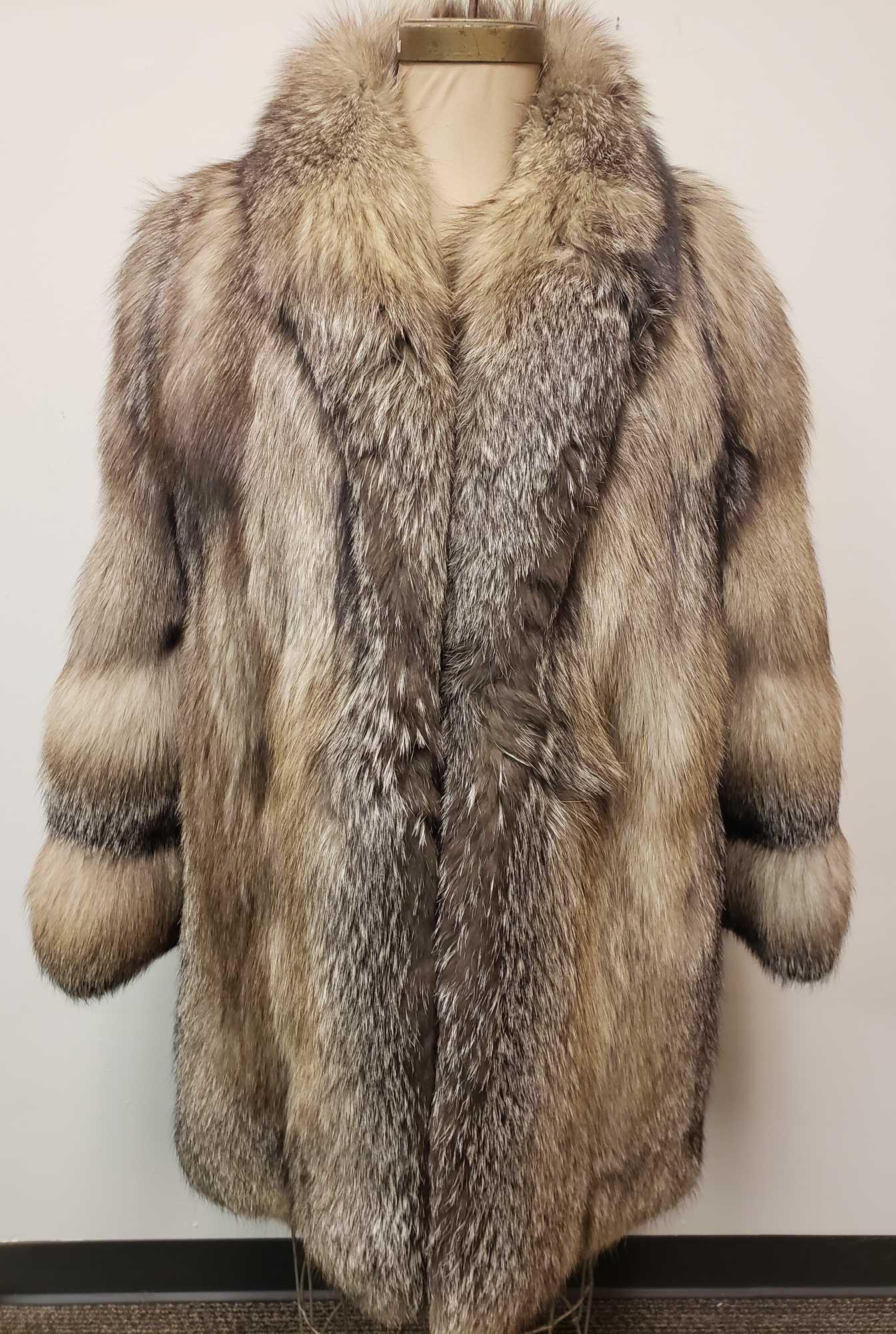 Gray Fox Fur Coat: Gray Fox Fur Coat. This fur coat is in fair used condition. The coat has two known rips in the lining/exterior (one at the back collar and one under the left arm). The interior is a colorful paisley f
