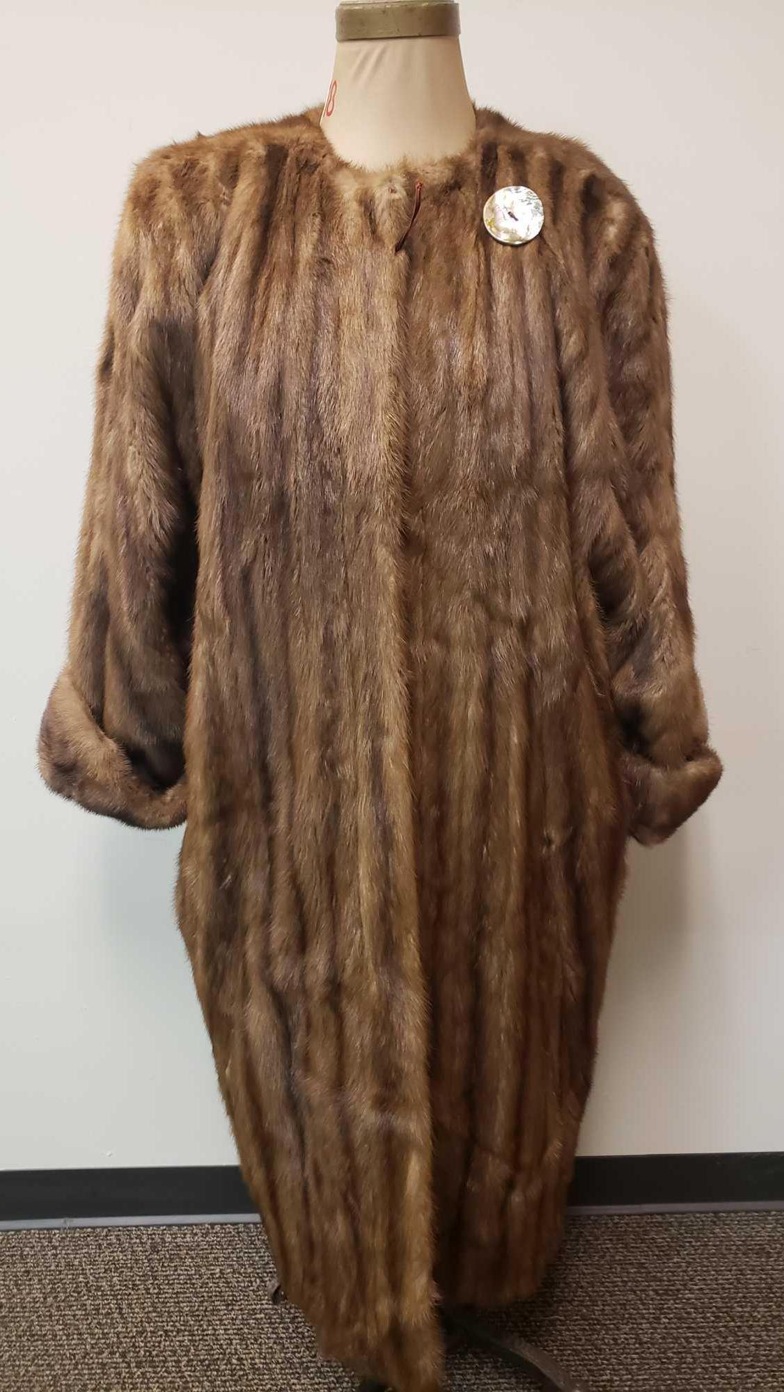 Full Length Mink Fur Coat: Full Length Mink Fur Coat. This mink fur coat is in good used condition. The only known sign of damage is that the top button loop has broken (see images). The interior of the coat has a paisley patte
