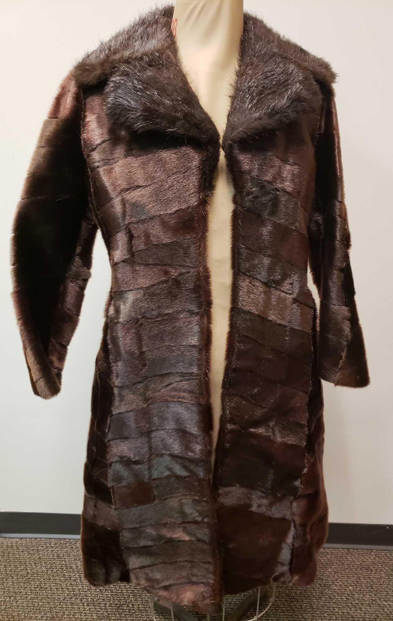 Three Quarters Length Seal Fur Coat: Three Quarters Length Seal Fur Coat. This fur coat is in great used condition. The coat has no known interior or exterior signs of damage to it. The interior of the coat is brown fabric with a size 38