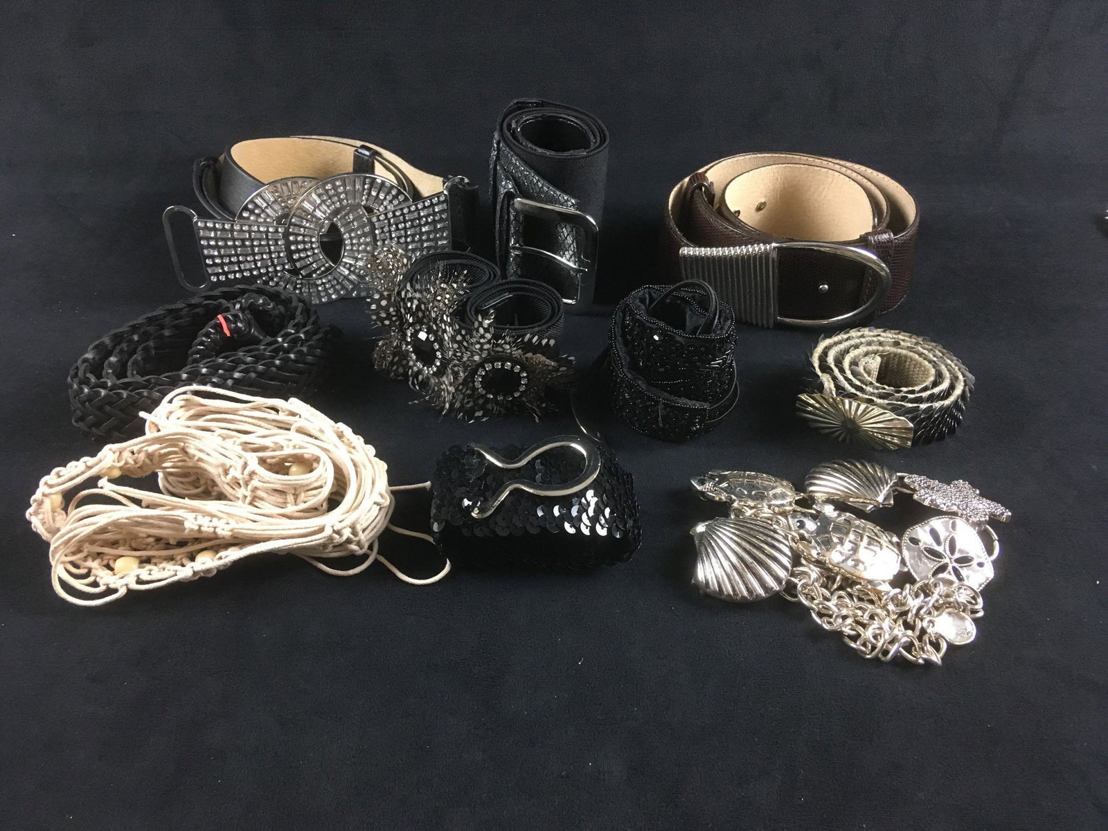 Set of 10 Women's Designer Belts: Set of 10 Women's Designer Belts. This set of belts is good condition. Most are from Chico's and are made of assorted materials. This set includes: 1 Chico's M/L leather belt with rhinestone buckle 1 