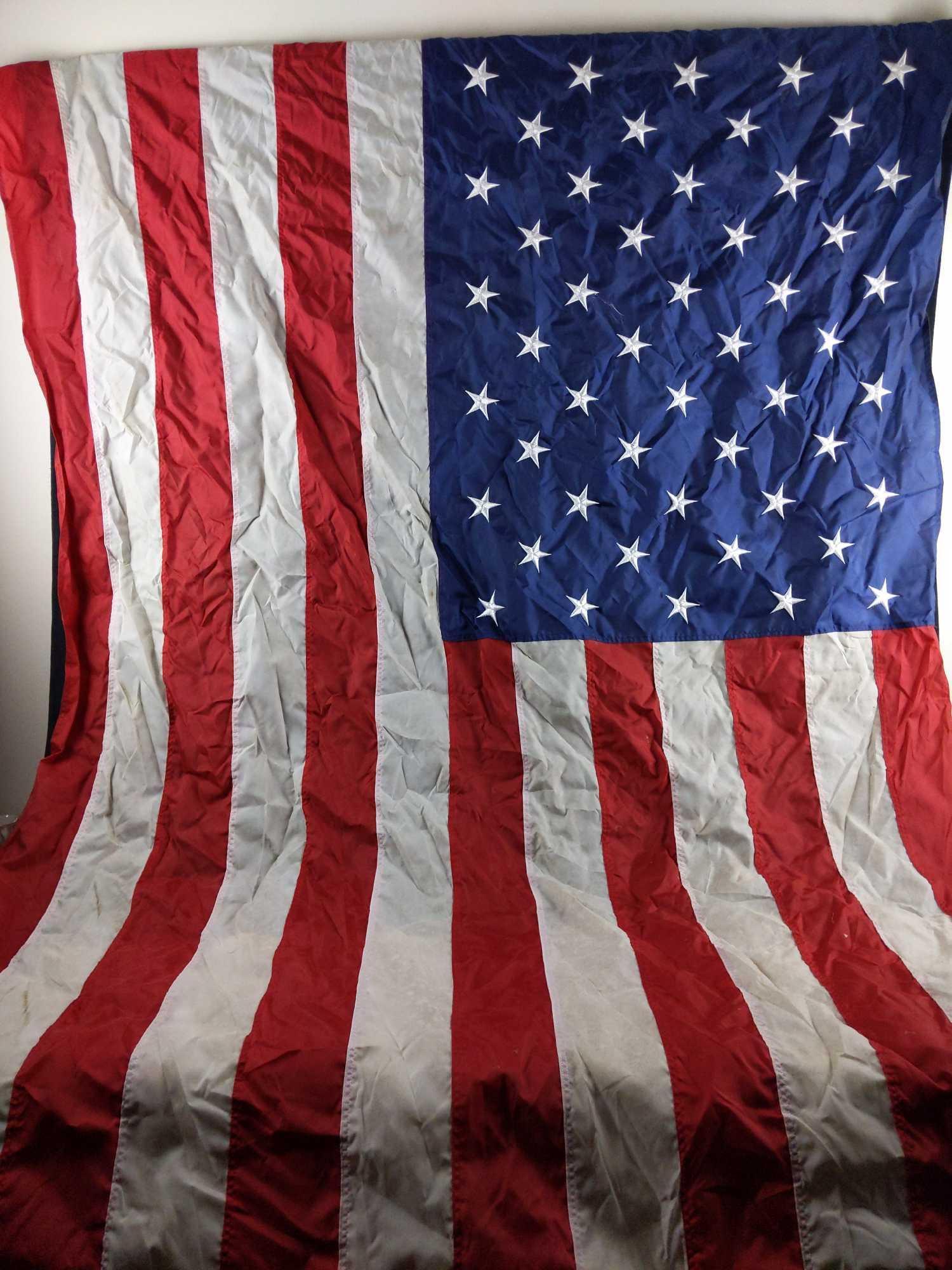 United States of America Nylon Embroideredd Flag: United States of America flag by Nyl-Glo. Each piece on this flag is stitched together and the stars are embroidered. There is some discoloration due to sun exposure and some staining (please see pict