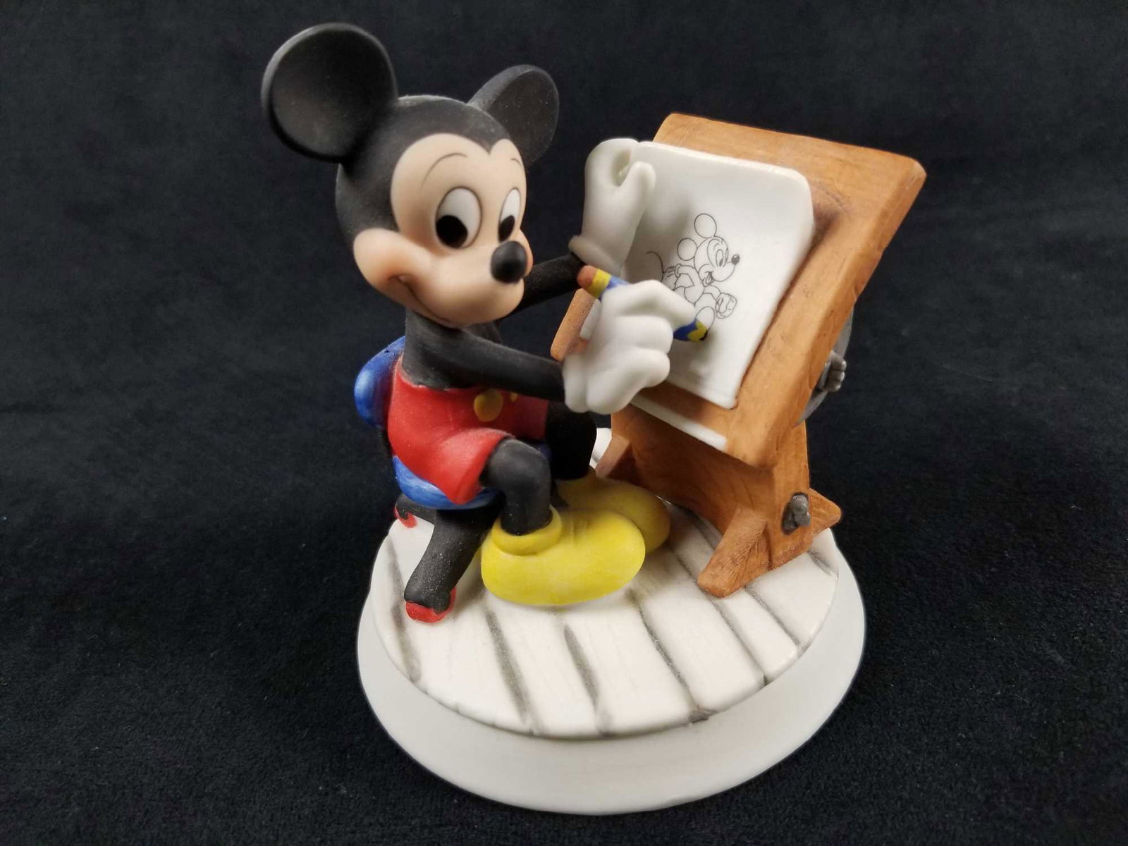 Disney Mickey Animator Drawing Board Figurine: Disney Mickey "Animator" Figurine. This figurine features a classic Mickey Mouse drawing a cartoon of himself on a drafting table. Figurine is in good used condition with no known damages. Bottom of t
