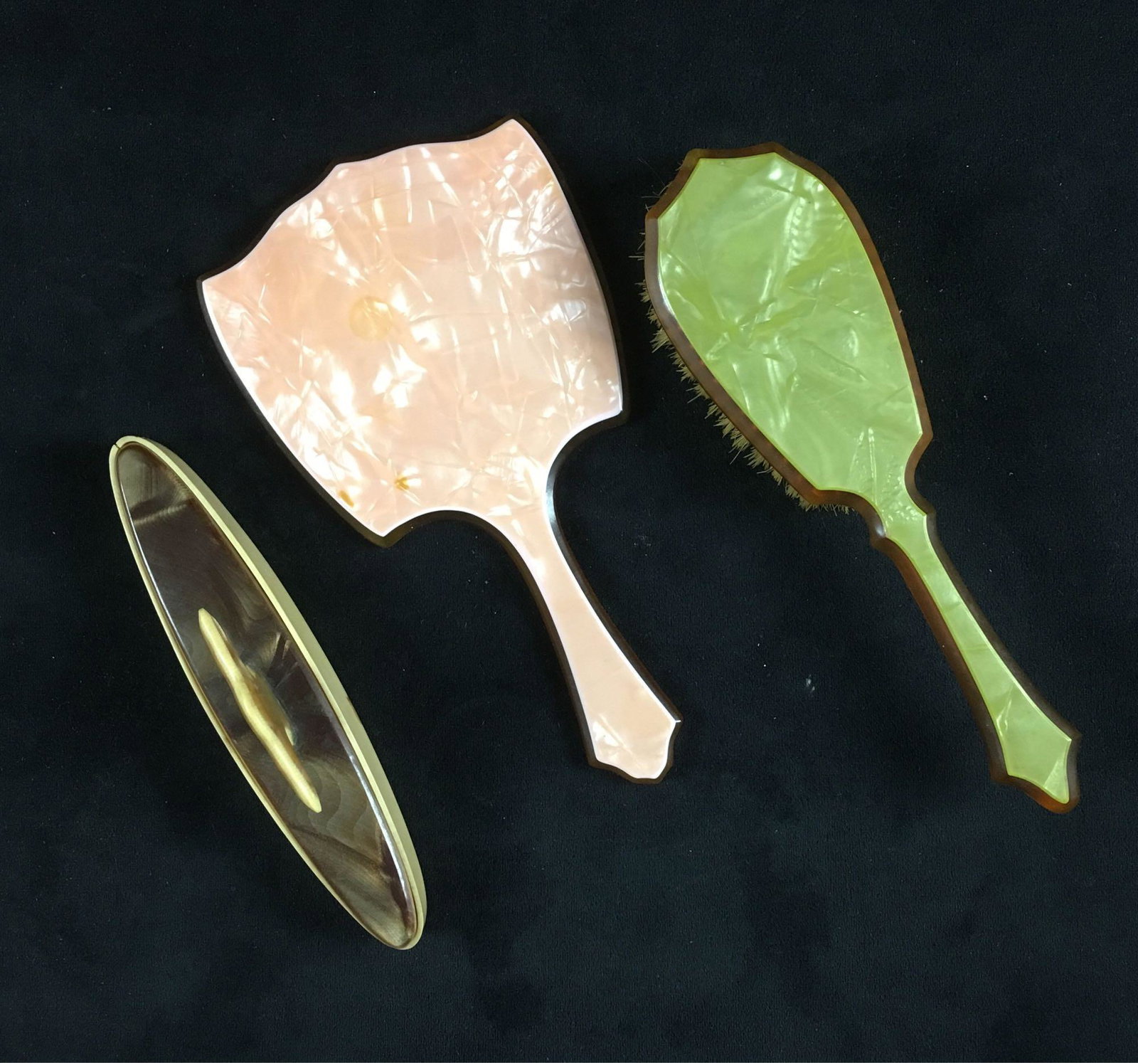 Vintage Celluloid Lucite Ladies Vanity 3 Piece: Vintage Celluloid Lucite Ladies Vanity 3 Piece Collection; lot includes; 1) a pink pearlized hand mirror with beveled mirror, in good condition, the mirror shows some spotting of the back and there ar
