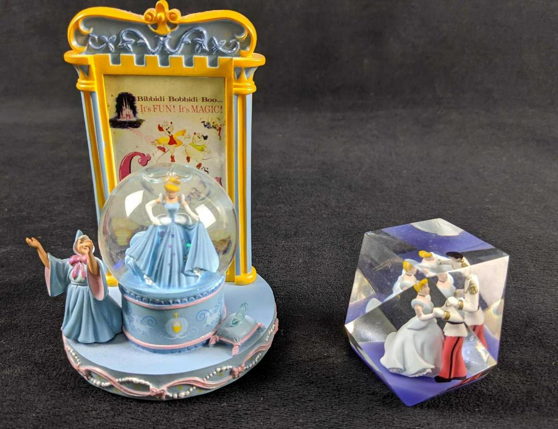 Disney Cinderella Movie Poster Snow Globe And Dance: This lot includes one Cinderella snow globe featuring Cinderella and the Fairy Godmother. Resin snow globe features many fun little details. Also in this lot is an Princess Cinderella and Prince Charm