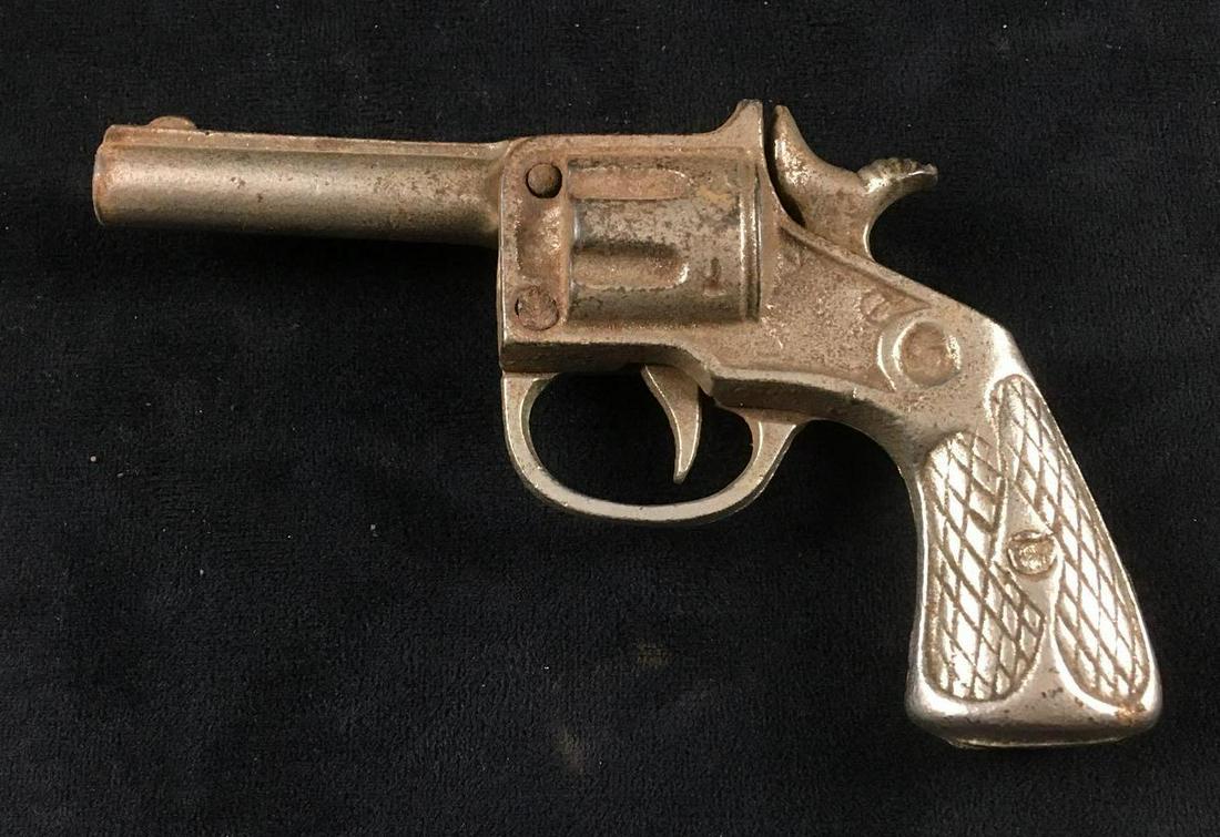Vintage Toy Cast Iron Cap Gun: Vintage Toy Cast Iron Cap Gun. This cap gun is in fair condition. It has some rust on the exterior. The hammer and the trigger on the gun are functional. The gun measures 5" L and 3.25" H.Â