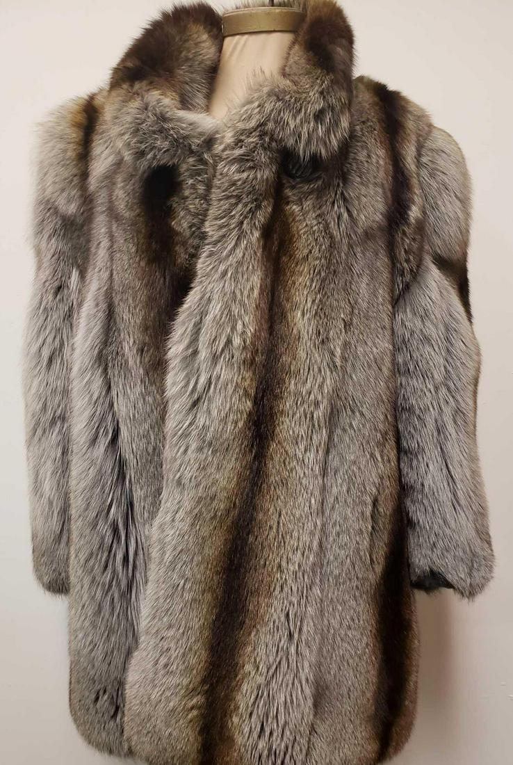 Gray and Brown Fox Fur Coat: Gray and Brown Fox Fur Coat. This fur coat is in great used condition. The coat has no known damage to it. The interior of the coat is linen and the manufacturer is unknown. The front has a hook and l