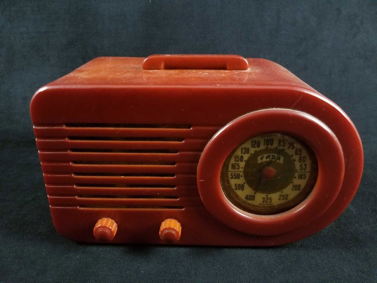 Fada Model 1000 Catalin Radio, Red Bakelite: This is a "bullet" table top radio, red Bakelite Case, from approximately 1946.Â This appears to be in the original condition.Â It does hum when turned on.Â There is a crack in the case under