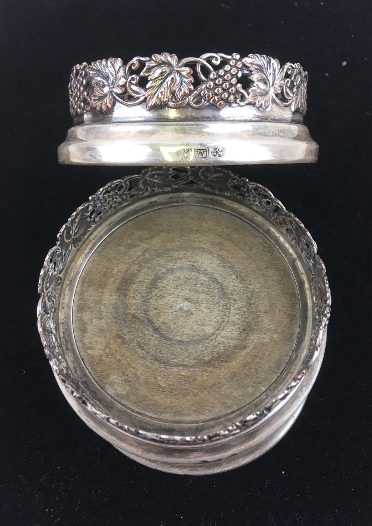 Antique British Sterling Silver Coasters: A set of 3 - sterling silver decorative candle bases or wine coasters with a grape vine design. Each piece weighs 63 grams and has a wood base surrounded in sterling. There are three hallmarks, one is