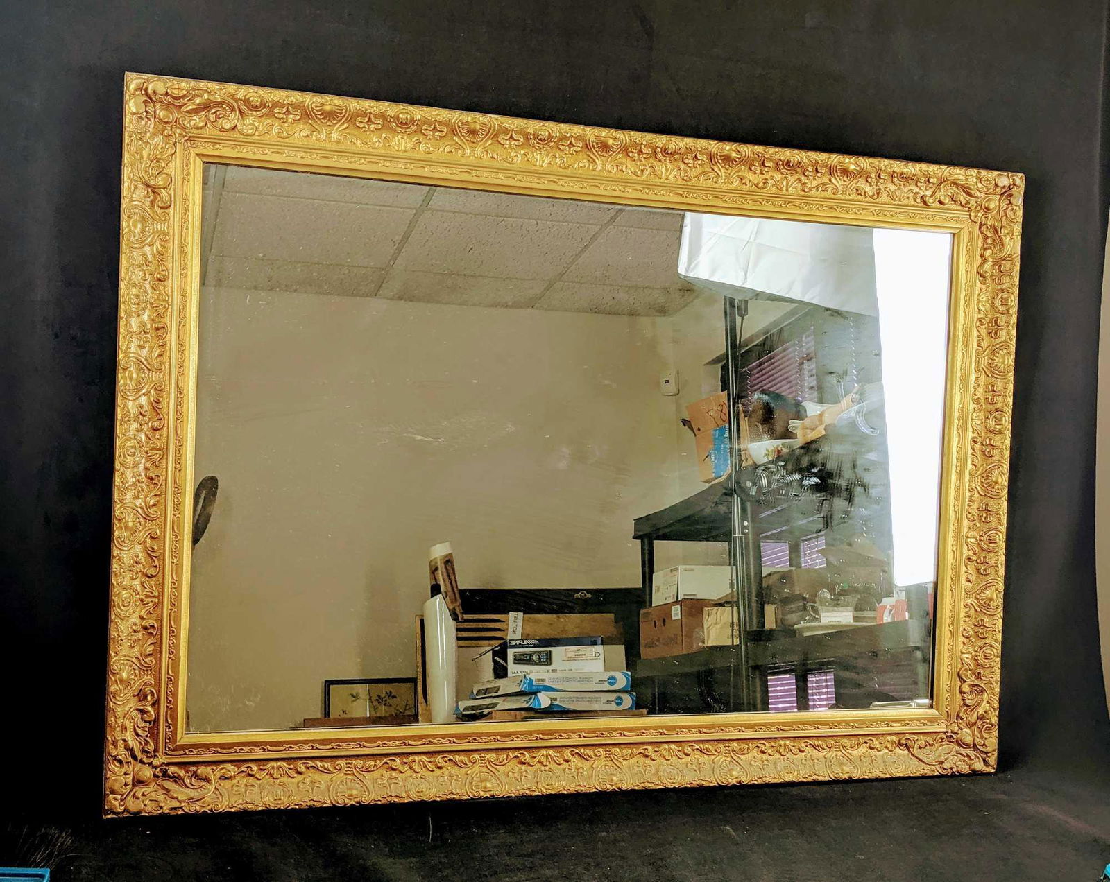 Large Ornate Antique Mirror: Very large gold toned gildedÂ framed mirror. Lovely Ornate detailing. Frame measures approx 41"x 29 1/2" and mirror measures approx 23"x35". Has some deep scratches and minor damages to frame, which