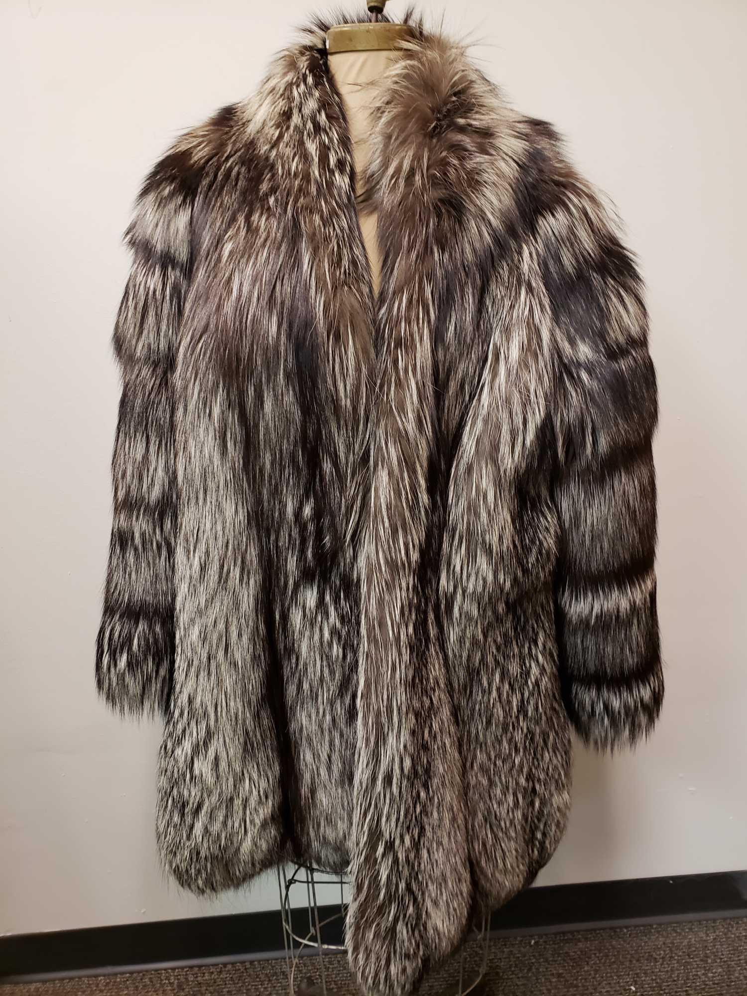 Silver Fox Fur Jacket: Silver Fox Fur Jacket. This fur coat is in great used condition. The coat has no known damages to the interior or exterior of the coat. The interior lining is silver fabric with a leaf pattern. The ja