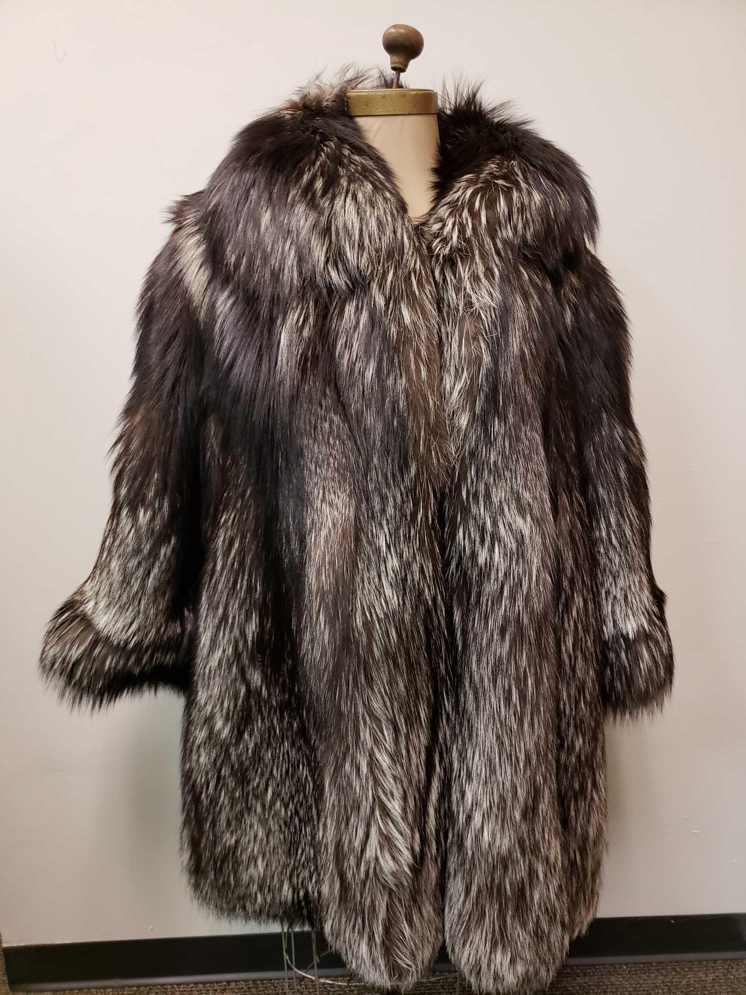 Silver Fox Fur Jacket: Silver Fox Fur Jacket. This fur coat is in great used condition. The coat has no known signs of damage on the interior or exterior. The interior has a gray fabric lining and the coat has a hook and lo