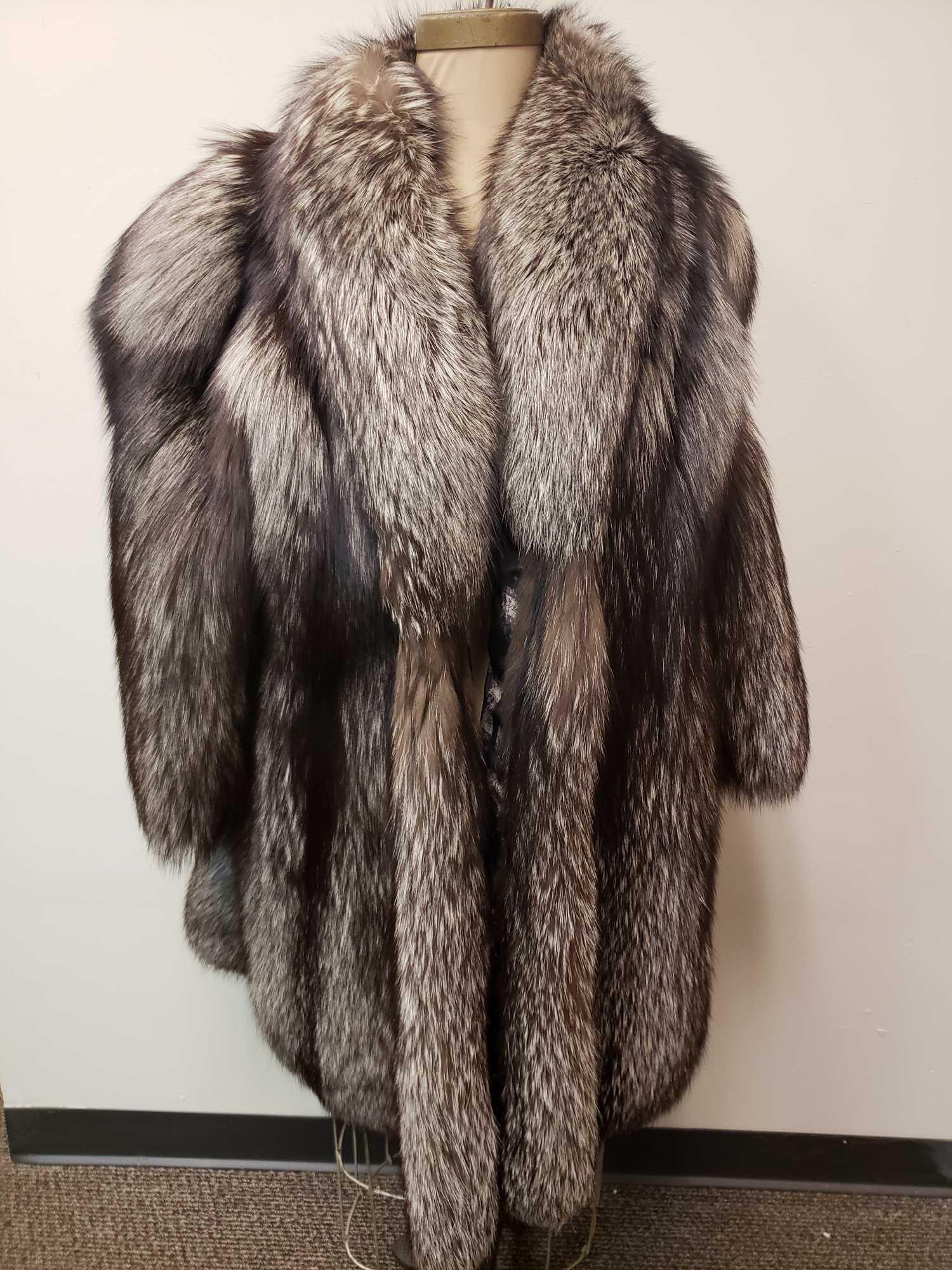 Team Pellicce Silver Fox Fur Coat: Team Pellicce Silver Fox Fur Coat. This coat is in great used condition. There is no known damage to the interior or exterior. The coat is presumed to be fox fur. The front has a hook and loop closure