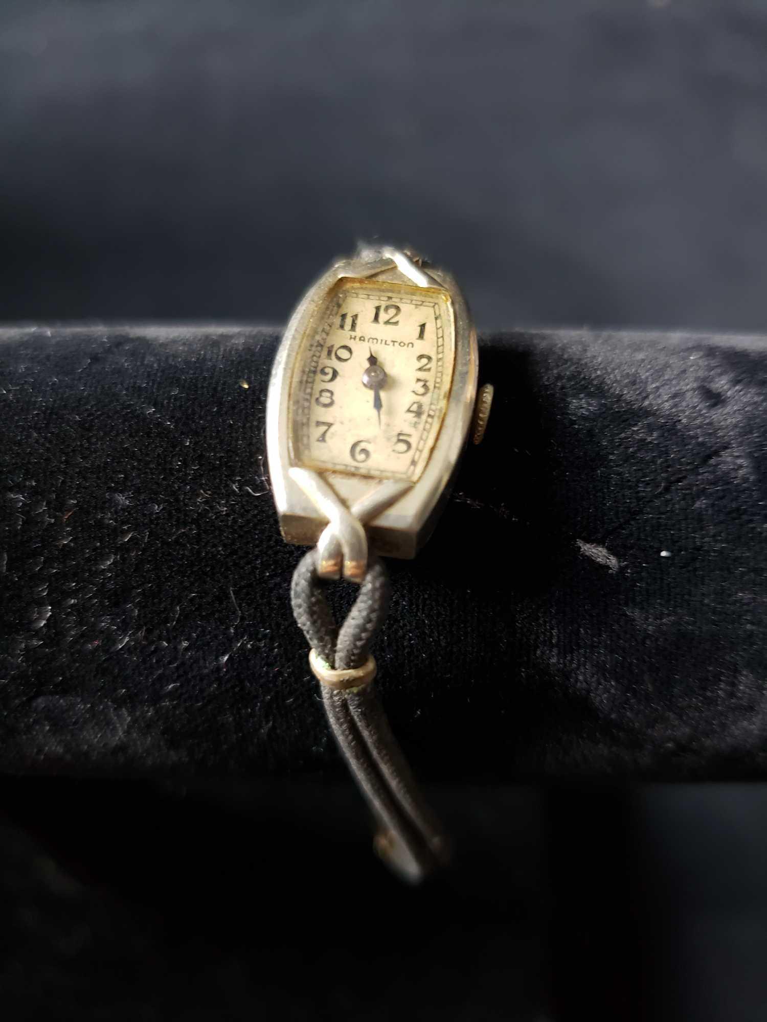 Hamilton Watch: Hamilton Watch. This watch is in good used condition. The band on the watch shows minor signs of fraying and the face has discoloration from age. The watch has a 14k gold case. Watch face measures app