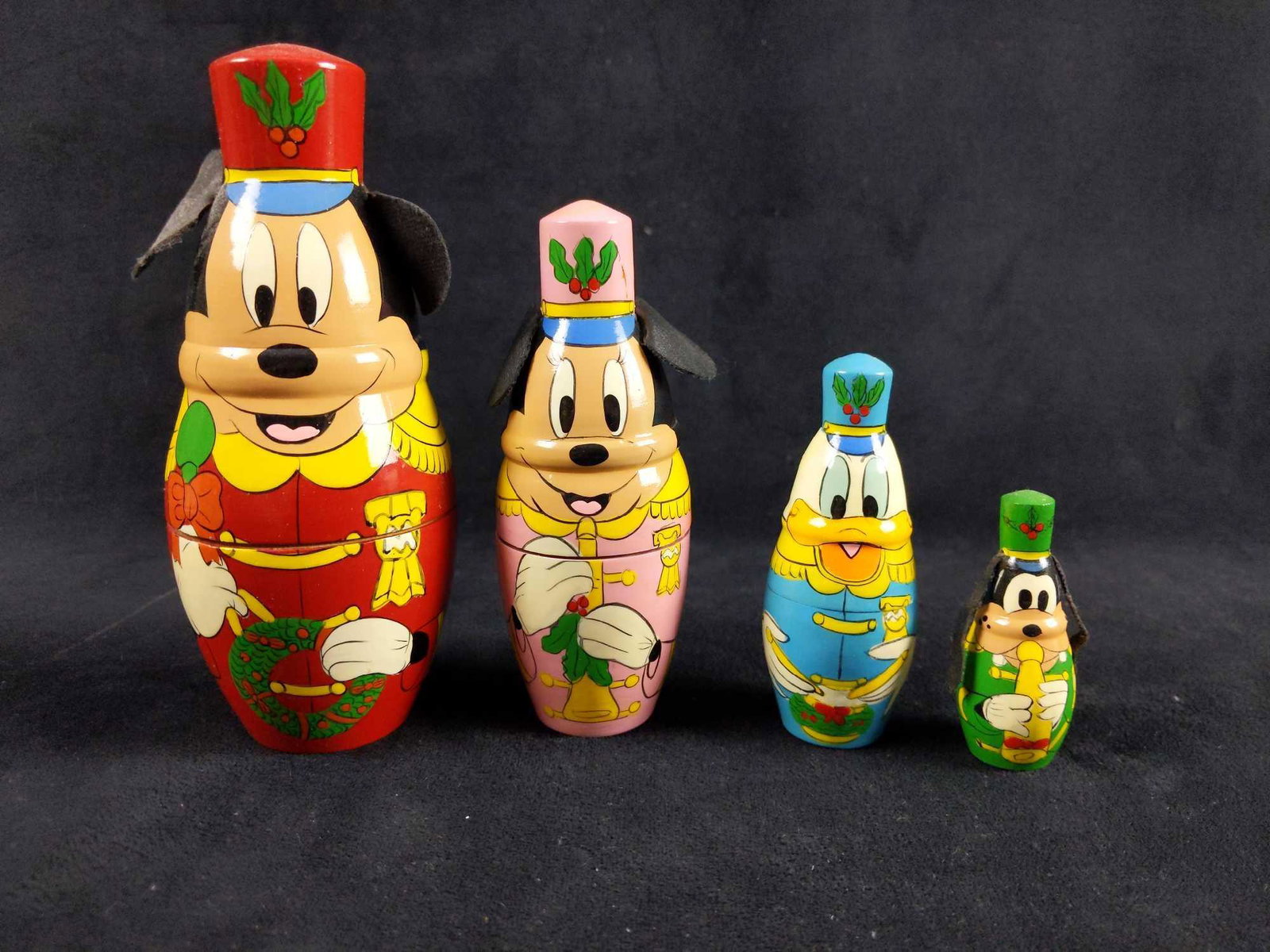 Handpainted Nesting Dolls Disney Christmas Parade: This listing is for a set of 4 nesting dolls hand painted in the likeness of Mickey, Minnie ,Donald and Goofy wearing Christmas parade outfits and playing their instruments. Mickey ,Minnie and Goofy h