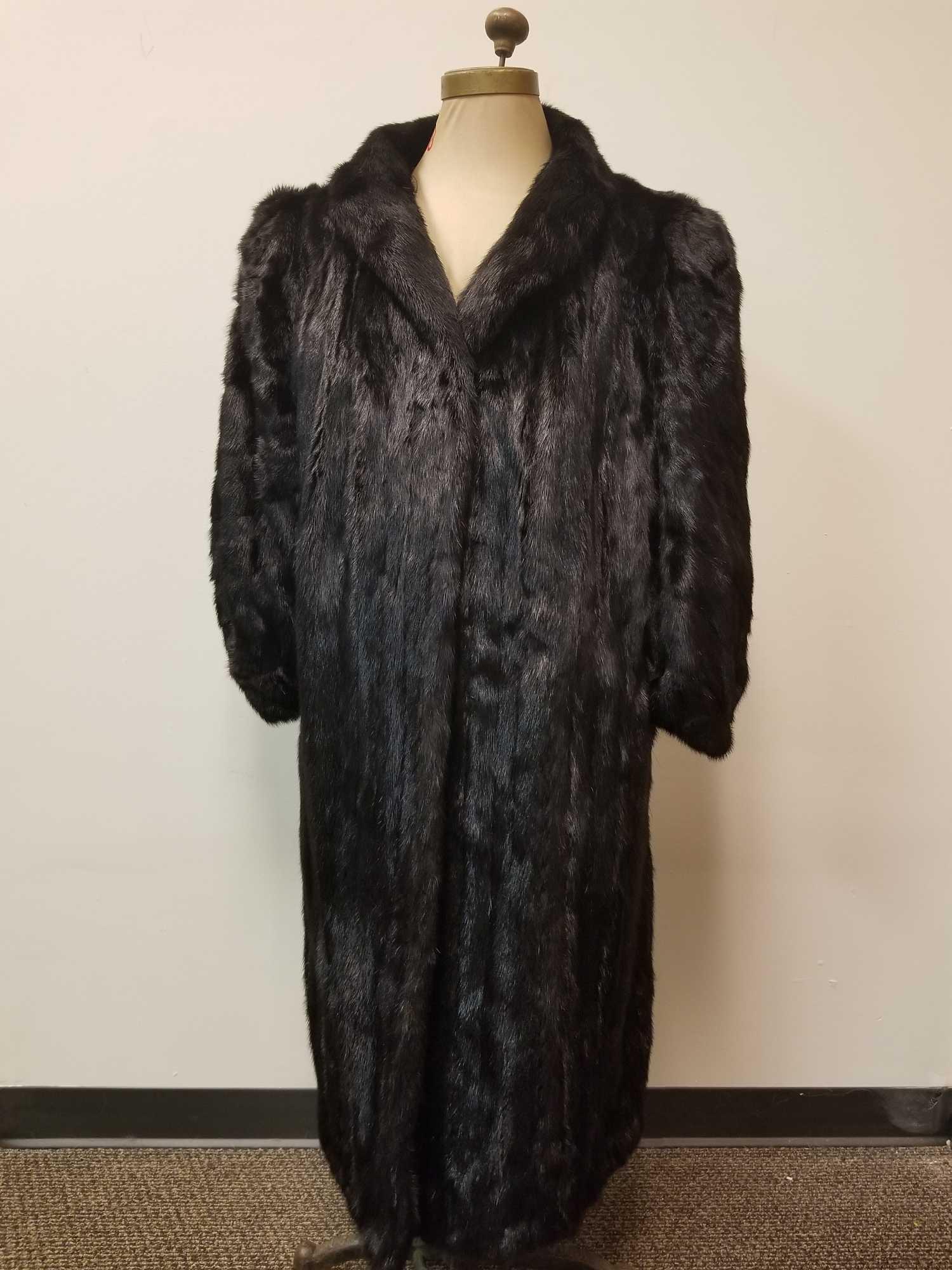 Scandinavian Saga Royal Mink Fur Coat: This stunning mink is in great used condition. There are no known obvious damage to interior or exterior. 4 hook and loop outside closures. Dark brown Interior lining. Approx Measurements: Hem 45 1/2"