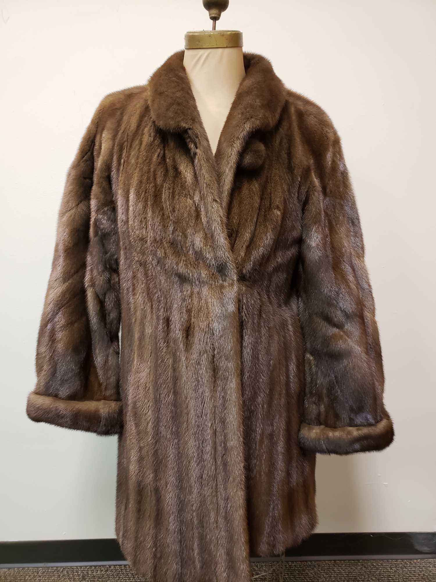 Peter Duffy Mink Fur Coat: Peter Duffy Mink Fur Coat. This fur coat is in great used condition. There are no known signs of damage to the interior or exterior of the coat. The coat has a light brown interior fabric lining with